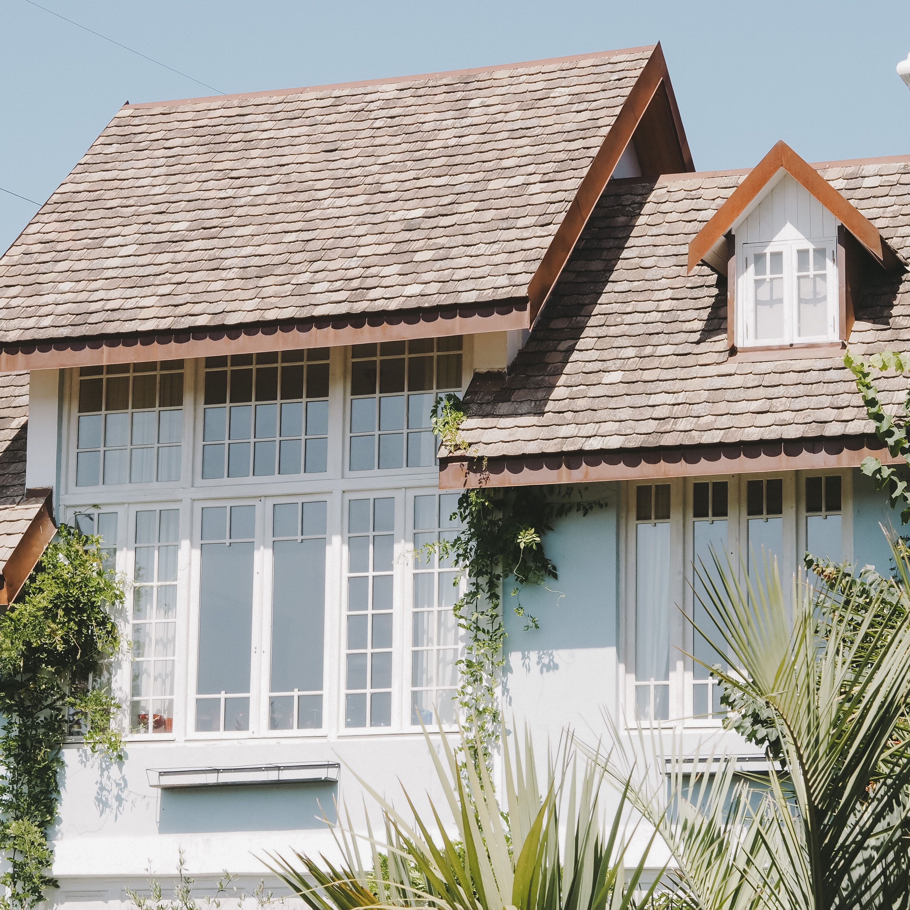 Distinctive home exterior with textured rooflines and tall windows